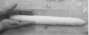 photo of hands shaping a baguette