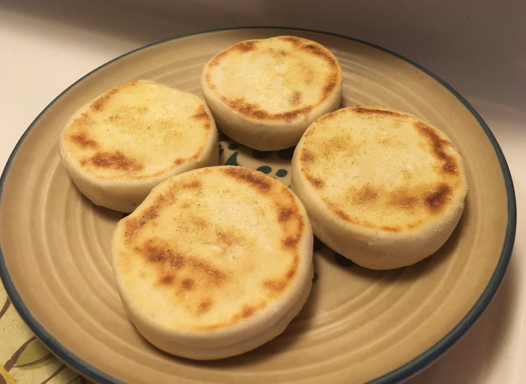 four English muffins on a plate